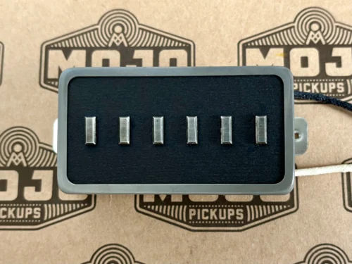 Six metal blade contacts mounted in a black rectangular housing, likely a guitar pickup component on Mojo Pickups packaging